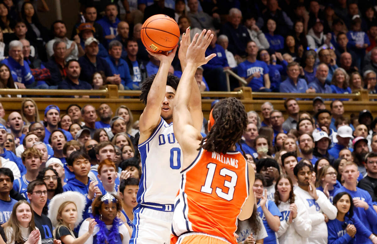 Duke’s Jared McCain (0) hits a three-pointer as Syracuse’s Benny Williams (13) defends during the second half of Duke’s 86-66 victory over Syracuse at Cameron Indoor Stadium in Durham, N.C., Tuesday, Jan. 2, 2024.