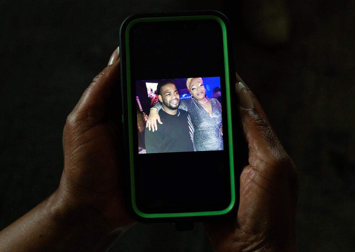 Henrietta Mason shows a photograph of herself with her son, Tyrone Mason.