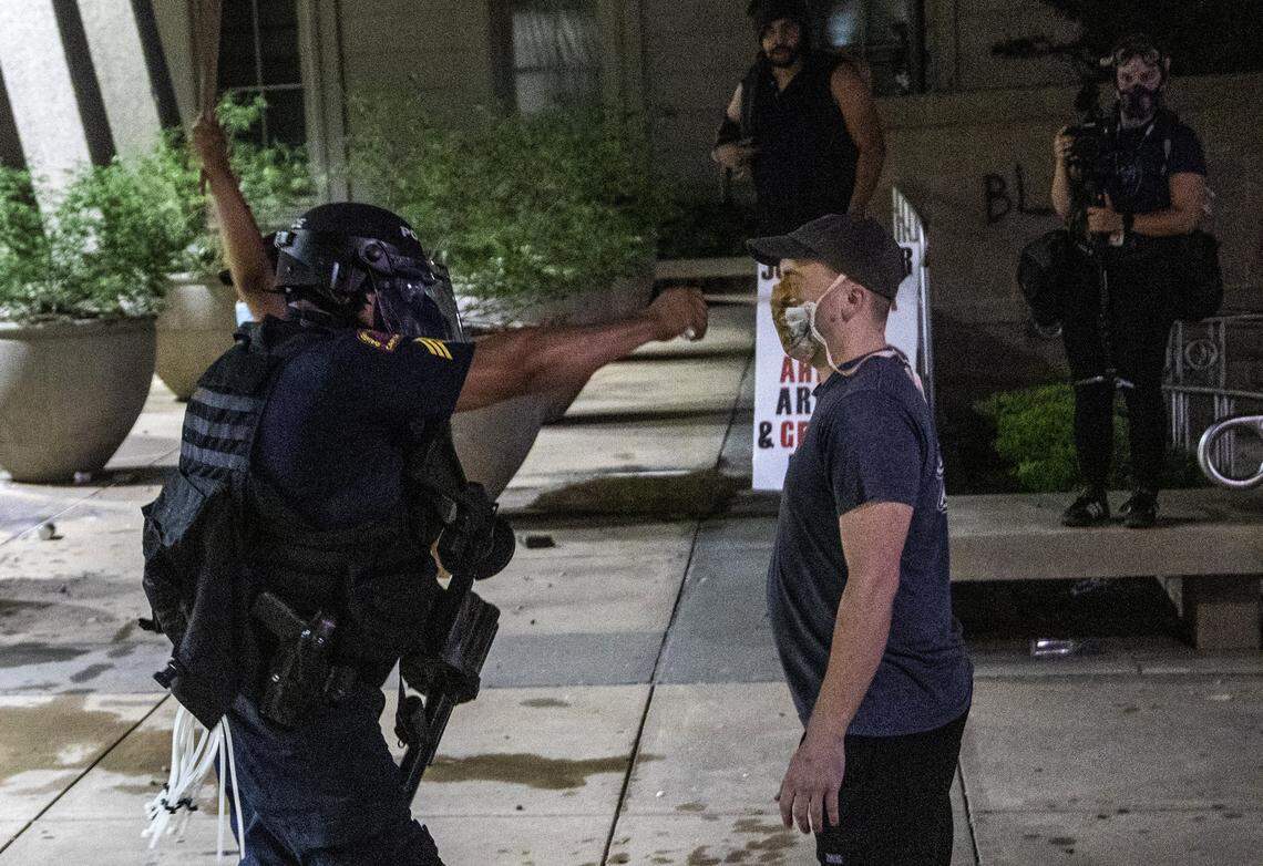 A protester is pepper sprayed at point blank range as police in riot gear deployed tear gas, pepper spray and smoke bombs against protesters in downtown Raleigh Saturday, May 30, 2020.