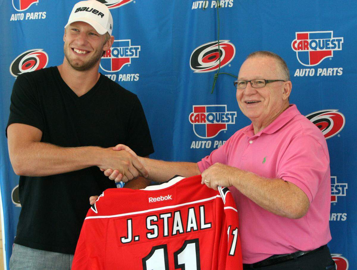 Jordan Staal, left, shakes hands with Carolina Hurricanes general manager Jim Rutherford during a press conference Friday, July 27, 2012, at the PNC Arena. Staal joined his brother Eric in the Hurricanes lineup after Rutherford negotiated a trade with the Pittsburgh Penguins.