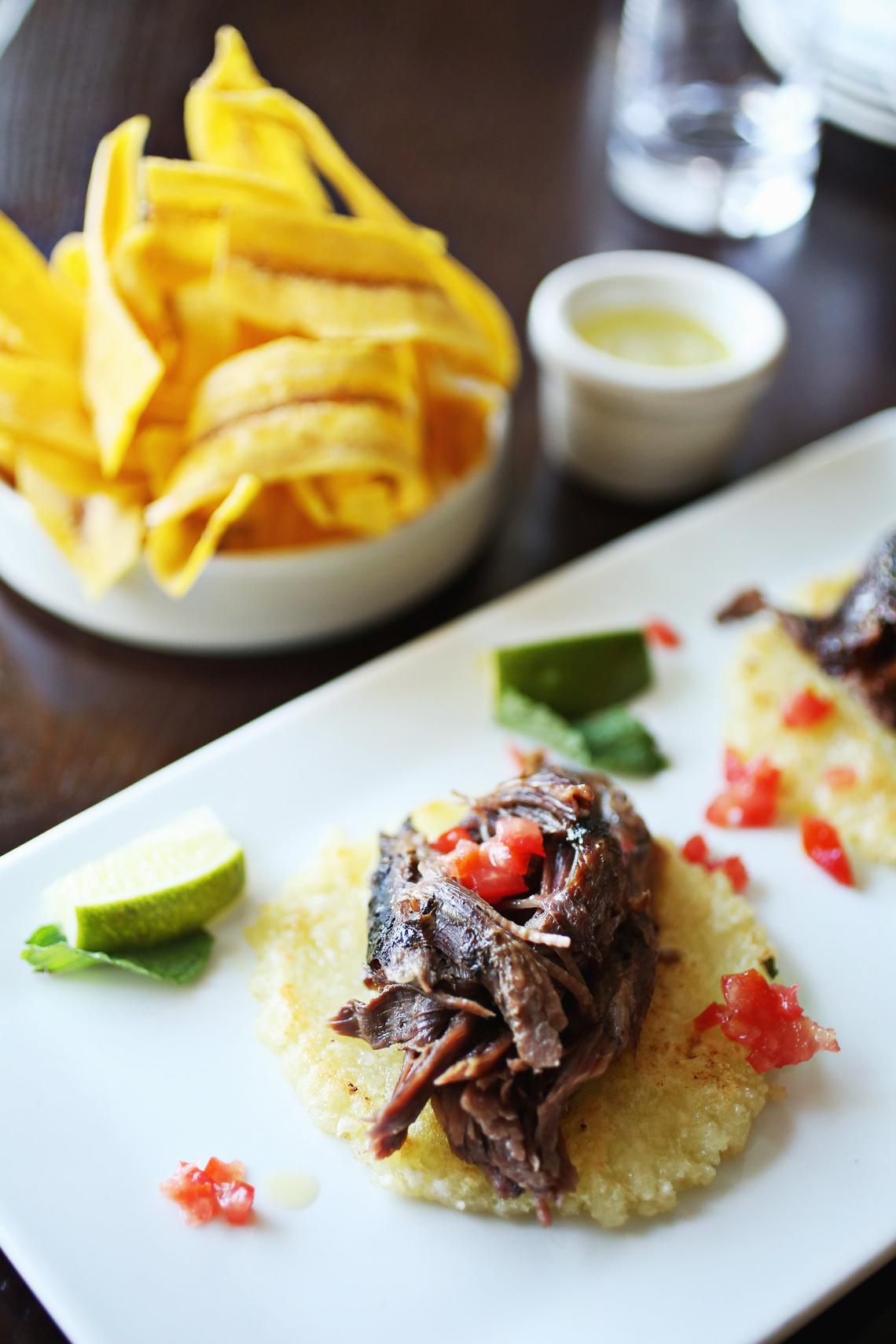 COPA’s Ropa vieja a la americana features NC grass-fed beef, slow-cooked with wine, mint, and a light tomato sauce served on crepe-like flatbreads made from cassava root. It is pictured here with an order of Plantain chips.