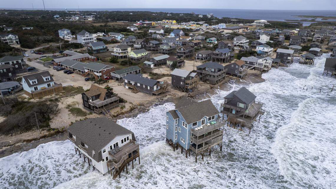 Rough surf threatens beach homes during high tide Friday morning, Oct. 10, 2025, in Buxton as a nor’easter approaches the North Carolina coast. Nine homes in the community have collapsed into the Atlantic Ocean since mid-September.