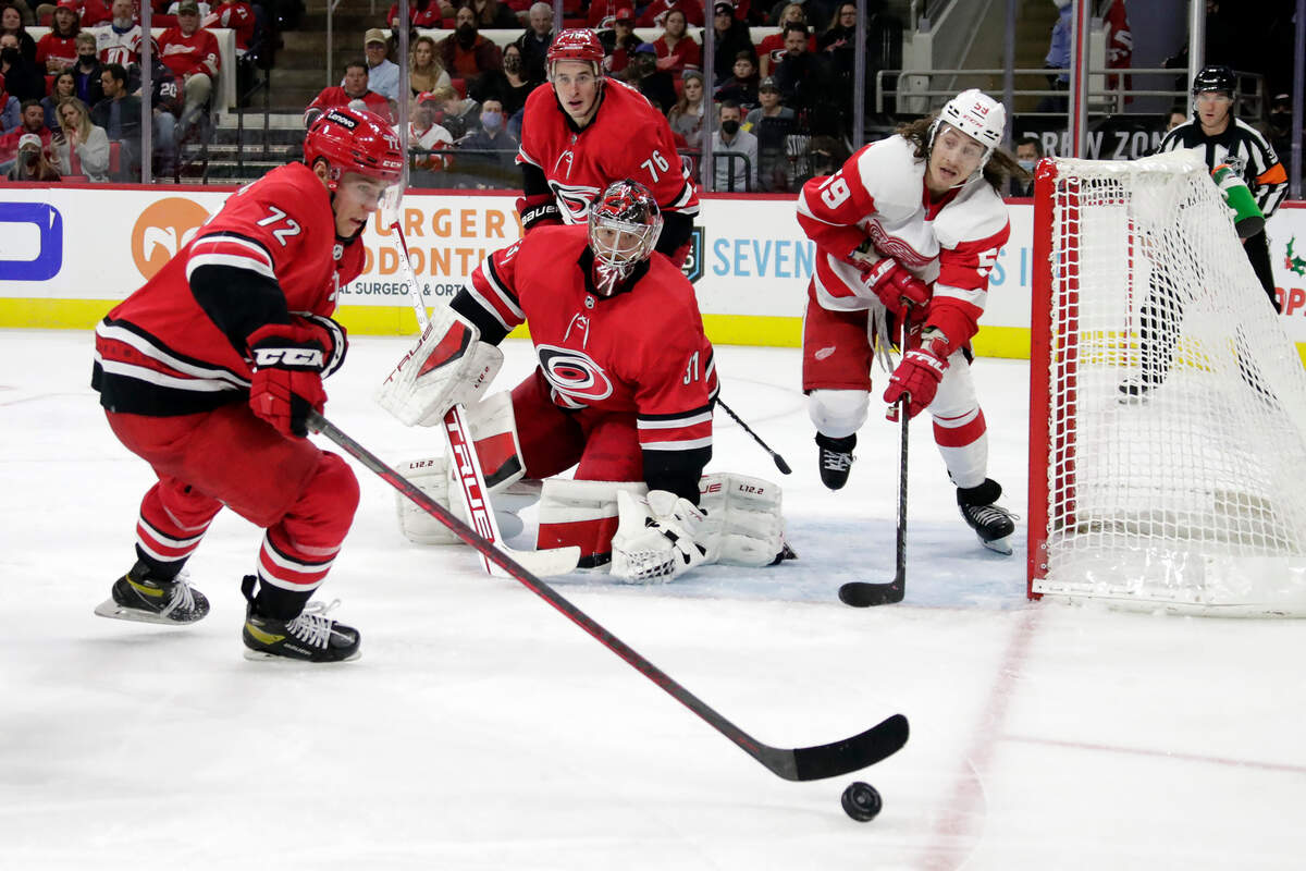 Carolina Hurricanes center Jack Drury (72), goaltender Frederik Andersen (31) and defenseman Brady Skjei (76) defend the net against Detroit Red Wings left wing Tyler Bertuzzi (59) during the third period of an NHL hockey game Thursday, Dec. 16, 2021, in Raleigh, N.C. (AP Photo/Chris Seward)