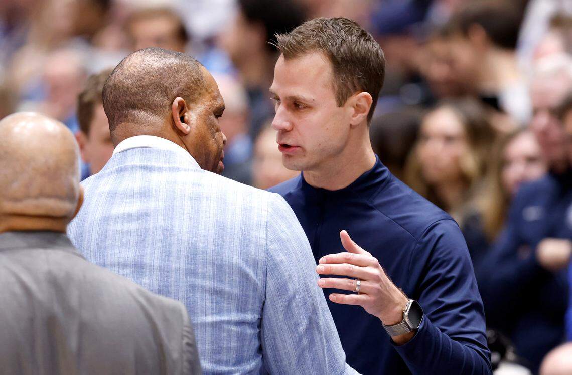 Duke head coach Jon Scheyer talks with North Carolina head coach Hubert Davis before Duke’s game against UNC at Cameron Indoor Stadium in Durham, N.C., Saturday, Feb. 1, 2025.
