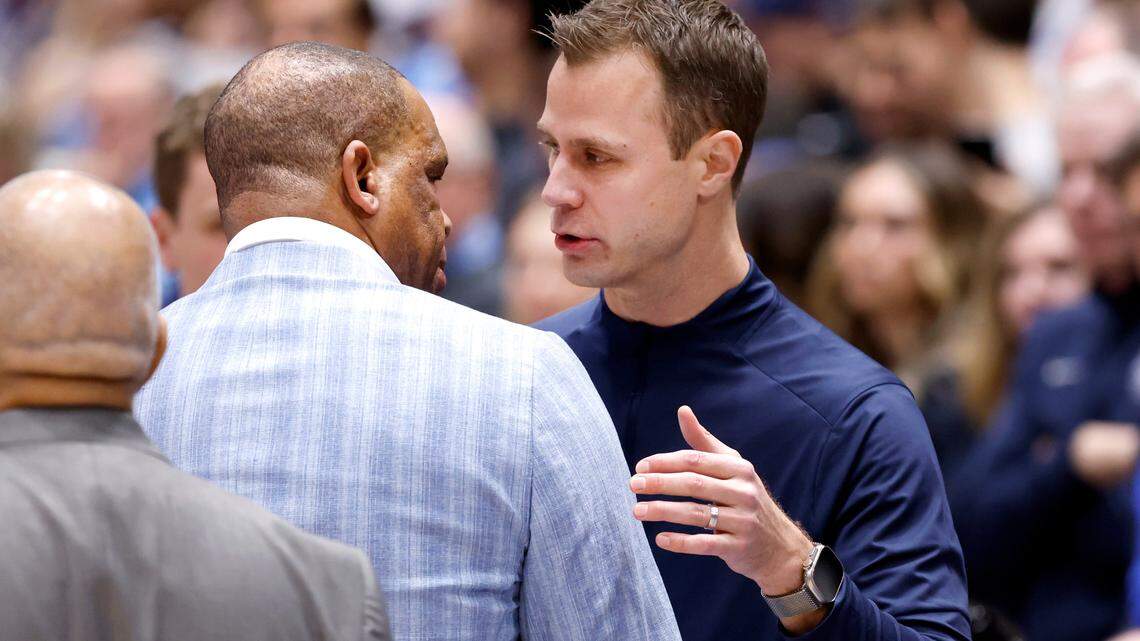 Duke head coach Jon Scheyer talks with North Carolina head coach Hubert Davis before Duke’s game against UNC at Cameron Indoor Stadium in Durham, N.C., Saturday, Feb. 1, 2025.