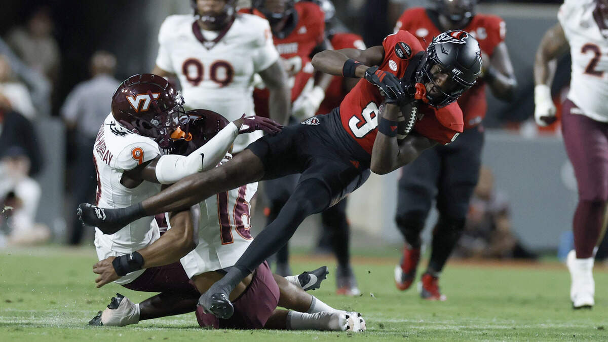 After making a reception, N.C. State wide receiver Terrell Anderson (9) is tackled by Virginia Tech linebacker Noah Chambers (16) during the first half of N.C. State’s game against Virginia Tech at Carter-Finley Stadium in Raleigh, N.C., Saturday, Sept. 27, 2025.