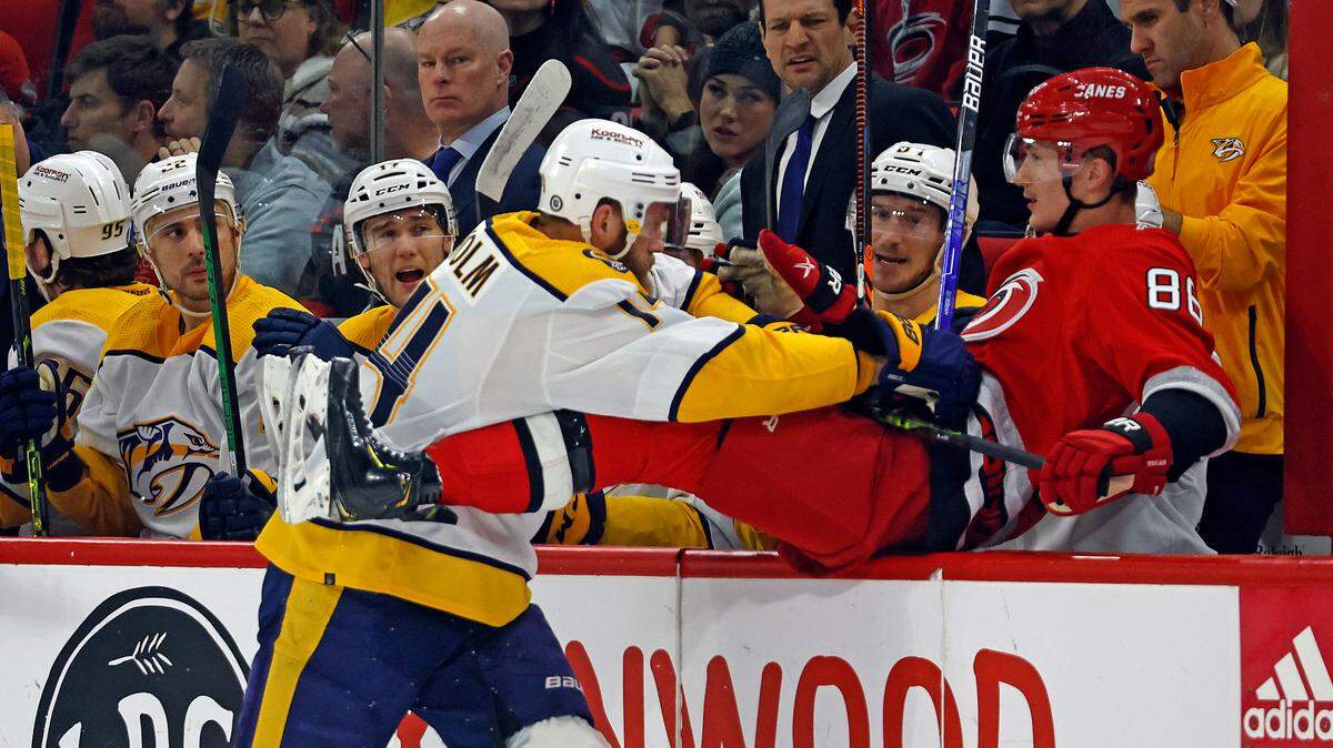 Carolina Hurricanes’ Martin Necas (88) is sent into the bench by Nashville Predators’ Mattias Ekholm (14) during the first period of an NHL hockey game in Raleigh, N.C., Thursday, Jan. 5, 2023. (AP Photo/Karl B DeBlaker)