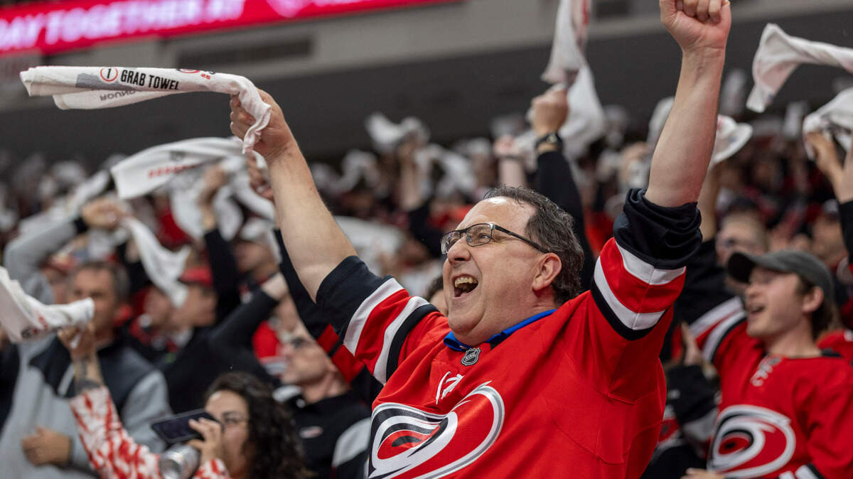 Carolina Hurricanes fan Todd Holmes celebrates following a goal by Shaye Gostisbehere (04) in the first period, to take a 1-0 lead against the Washington Capitals during Game 4 of their series on Monday, May 12, 2025 at Lenovo Center in Raleigh, N.C.