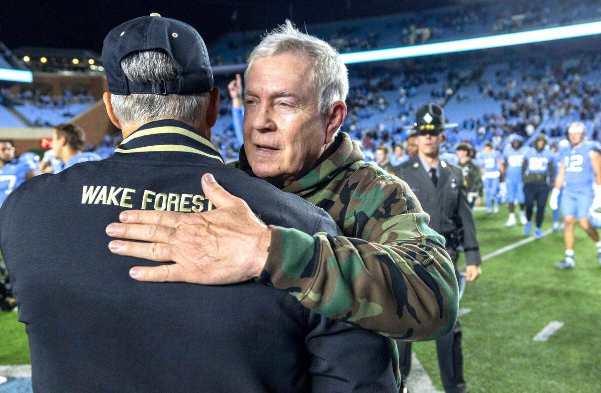 North Carolina coach Mack Brown embraces Wake Forest coach Dave Clawson following the Tar Heels’ 31-24 victory on Saturday, November 16, 2024 at Kenan Stadium in Chapel Hill, N.C.