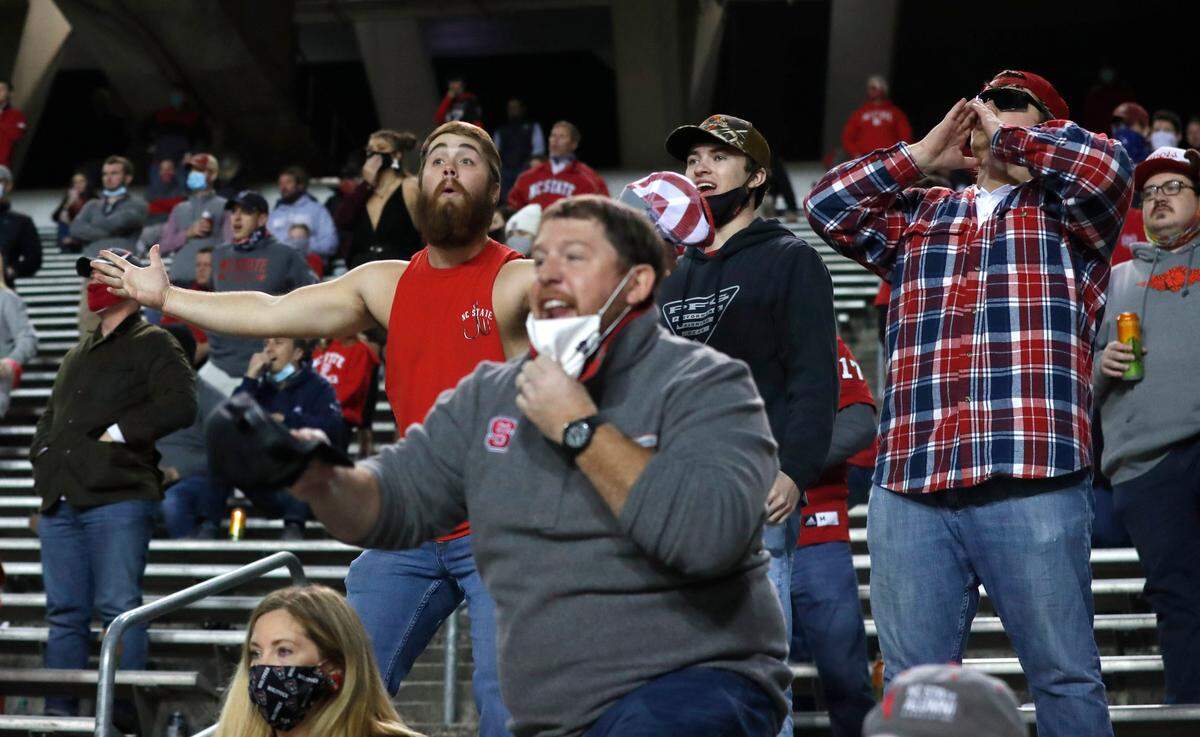 Wolfpack fans are not happy with the official’s call during the second half of N.C. State’s 15-14 victory over Liberty at Carter-Finley Stadium in Raleigh, N.C., Saturday, Nov. 21, 2020.