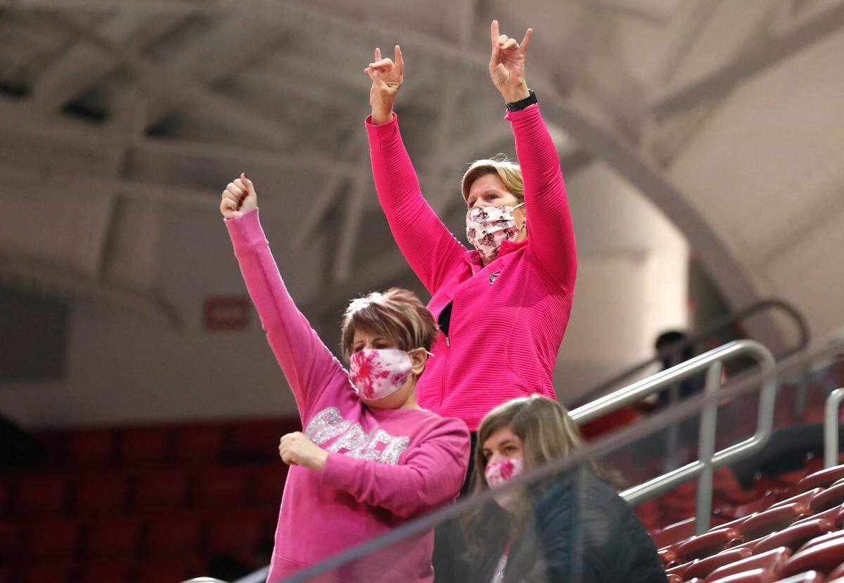 N.C. State fans cheer on the Wolfpack during the second half of N.C. State’s 82-63 victory over UNC in the annual Play4Kay game at Reynolds Coliseum in Raleigh, N.C., Sunday, February 21, 2021.