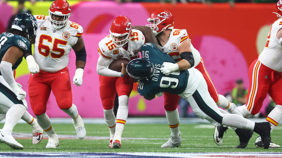 Feb 9, 2025; New Orleans, LA, USA; Kansas City Chiefs quarterback Patrick Mahomes (15) is tackled by Philadelphia Eagles defensive tackle Jordan Davis (90) in Super Bowl LIX between the Philadelphia Eagles and the Kansas City Chiefs at Ceasars Superdome.