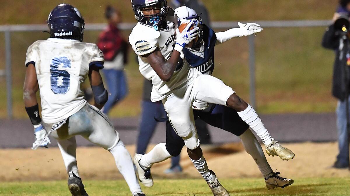 Millbrook’s Session McArthur (5) makes the interception against Hillside’s Tahir Henry (2) in the first half. The Hillside Hornets and the Millbrook Wildcats met in the NCHSAA 4a fourth round playoff game in Durham, NC, on November 25, 2022.