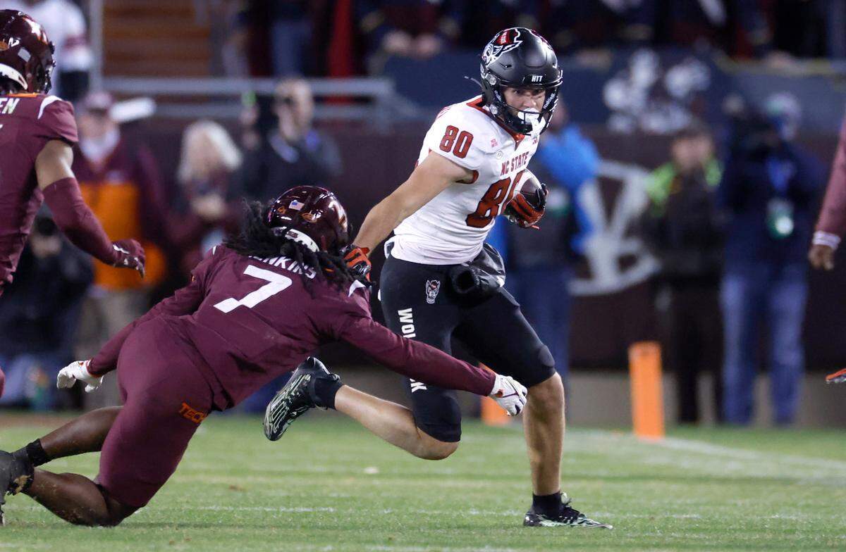 N.C. State wide receiver Bradley Rozner (80) avoids the tackle by Virginia Tech safety Keonta Jenkins (7) during the second half of N.C. State’s 35-28 victory over Virginia Tech at Lane Stadium in Blacksburg, VA, Saturday, Nov. 18, 2023.
