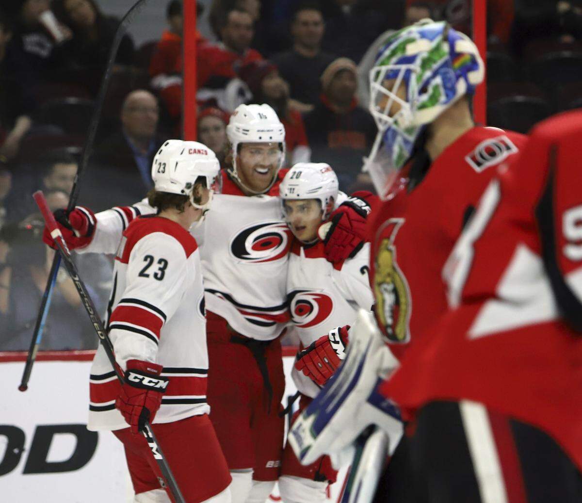 Carolina Hurricanes’ Dougie Hamilton (19) celebrates his goal against the Ottawa Senators with teammates Brock McGinn (23) and Sebastian Aho (20) during second-period NHL hockey play in Ottawa, Ontario, Sunday, Jan. 6, 2019. (Fred Chartrand/The Canadian Press via AP)