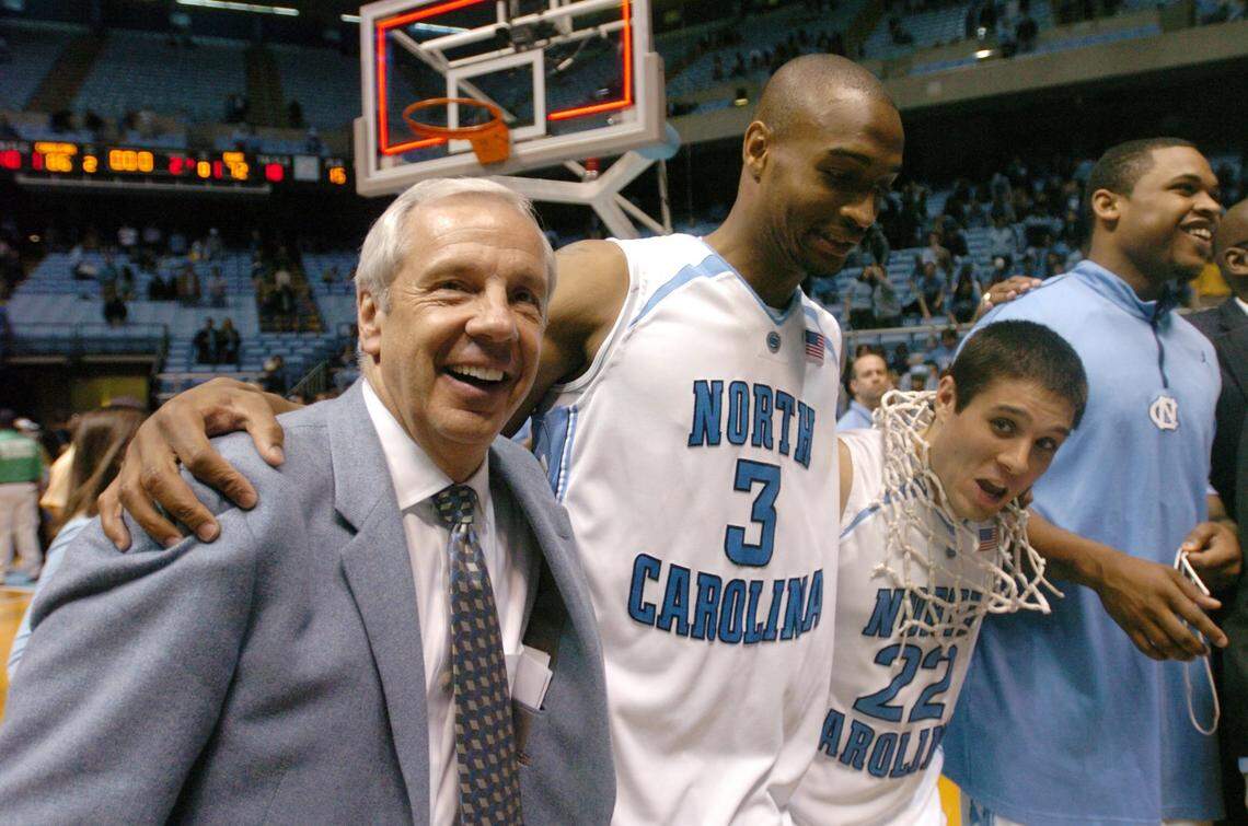 UNC senior Wes Miller (22), with a game net around his neck, celebrates the win over Duke with Reyshawn Terry (3) and coach Roy Williams in 2007.