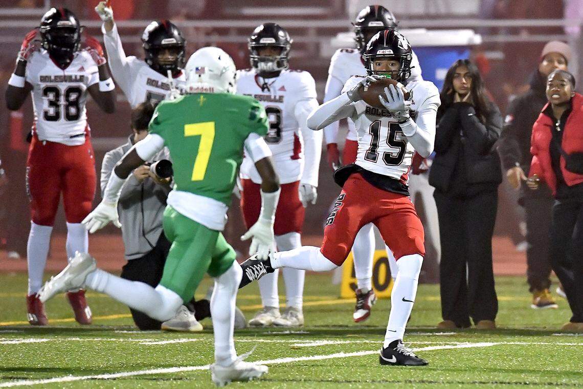 Rolesville wide receiver AJ Roberts (15) makes the catch and runs for the first down against Cardinal Gibbons during the first half. The Rolesville Rams and the Cardinal Gibbons Crusaders met in the East Regional Final of the NCHSAA 4A football playoffs in Raleigh, N.C. on December 13, 2024.