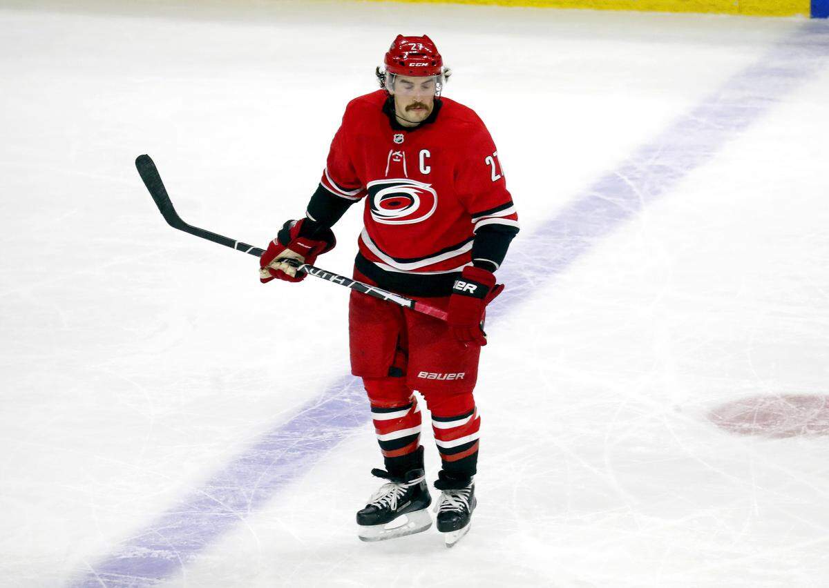 Dejected Canes' captain Justin Faulk (27) skates out of the penalty box after the Bruins scored its fifth goal of the game during the third period.  The Bruins beat the Canes 6-4.