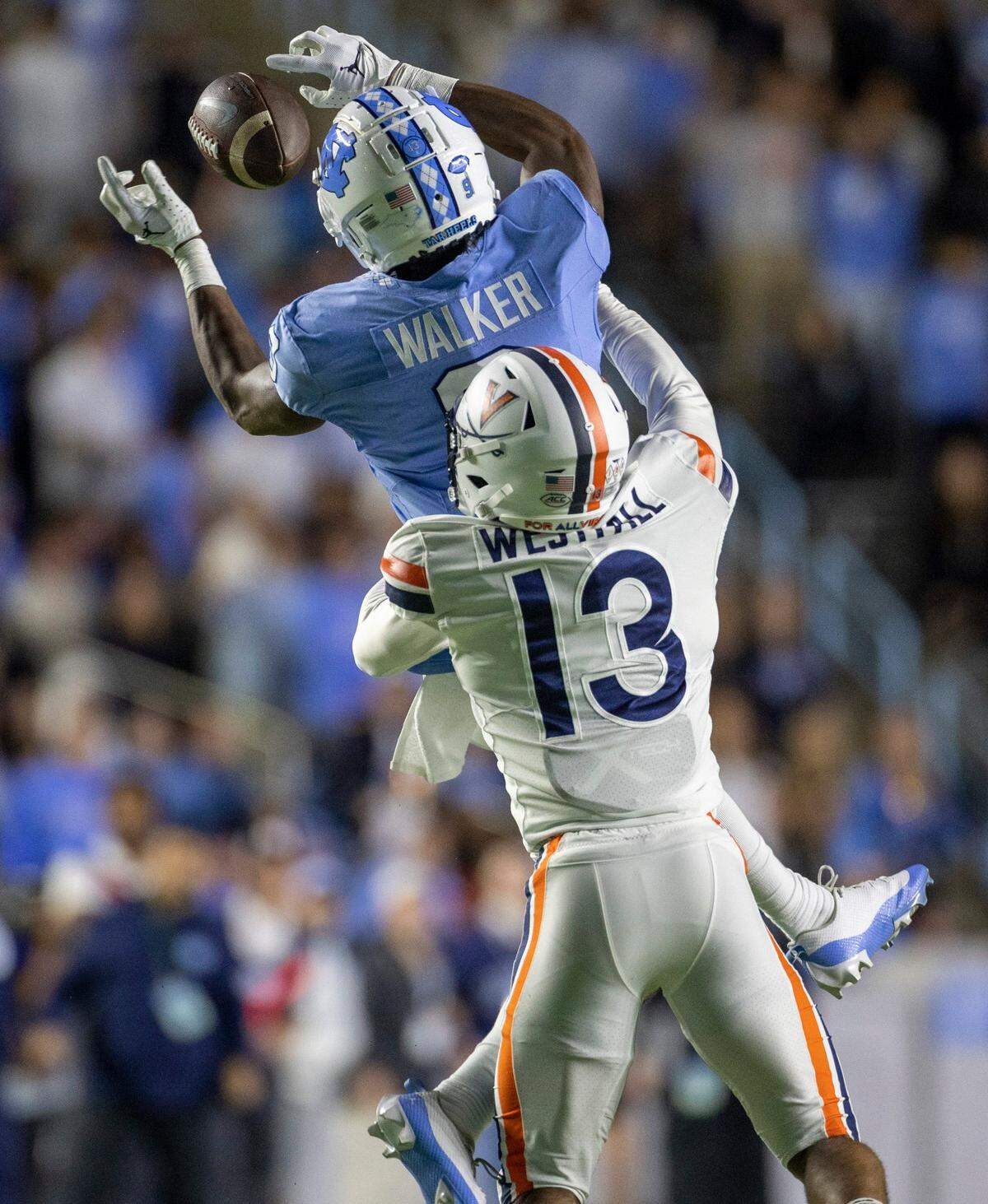 Virginia’s Sam Westfall (13) defends North Carolina wide receiver Devontez Walker (9) in the first quarter on Saturday, October 21, 2023 at Kenan Stadium in Chapel Hill, N.C.