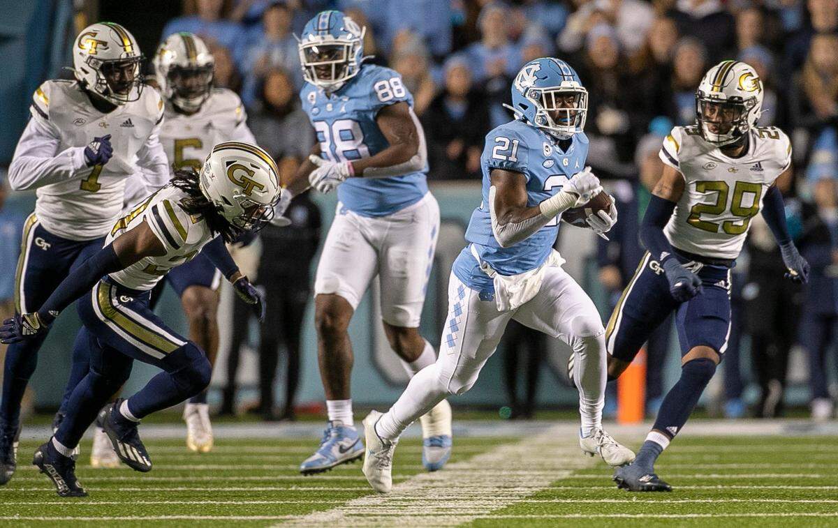 North Carolina’s Elijah Green (21) rushes 80 yards for a touchdown in the first quarter against Georgia Tech’s on Saturday, November 19, 2022 at Kenan Stadium in Chapel Hill, N.C.