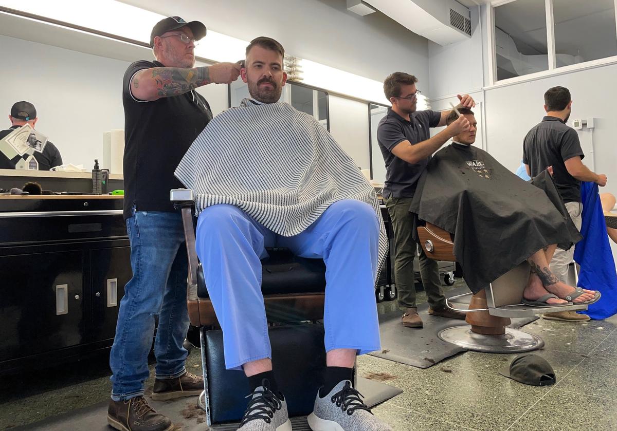Jeff Knox (at left) and his son Phil Knox cared for a steady flow of clients at Main Street Barber Shop on Wednesday, May 7, 2025. Owner Jeremy Anderson (at far right) rents out chairs to the Knoxes and a fourth barber, all of whom worked at Friendly Barber Shop.