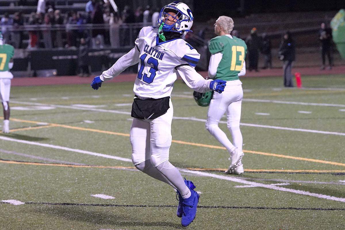 Clayton's Akedran Crumel (13) celebrates his team's impending victory over Cardinal Gibbons in the final minute of the East Regional Final of the NCHSAA 7A Football Championship in Clayton on Dec. 4.