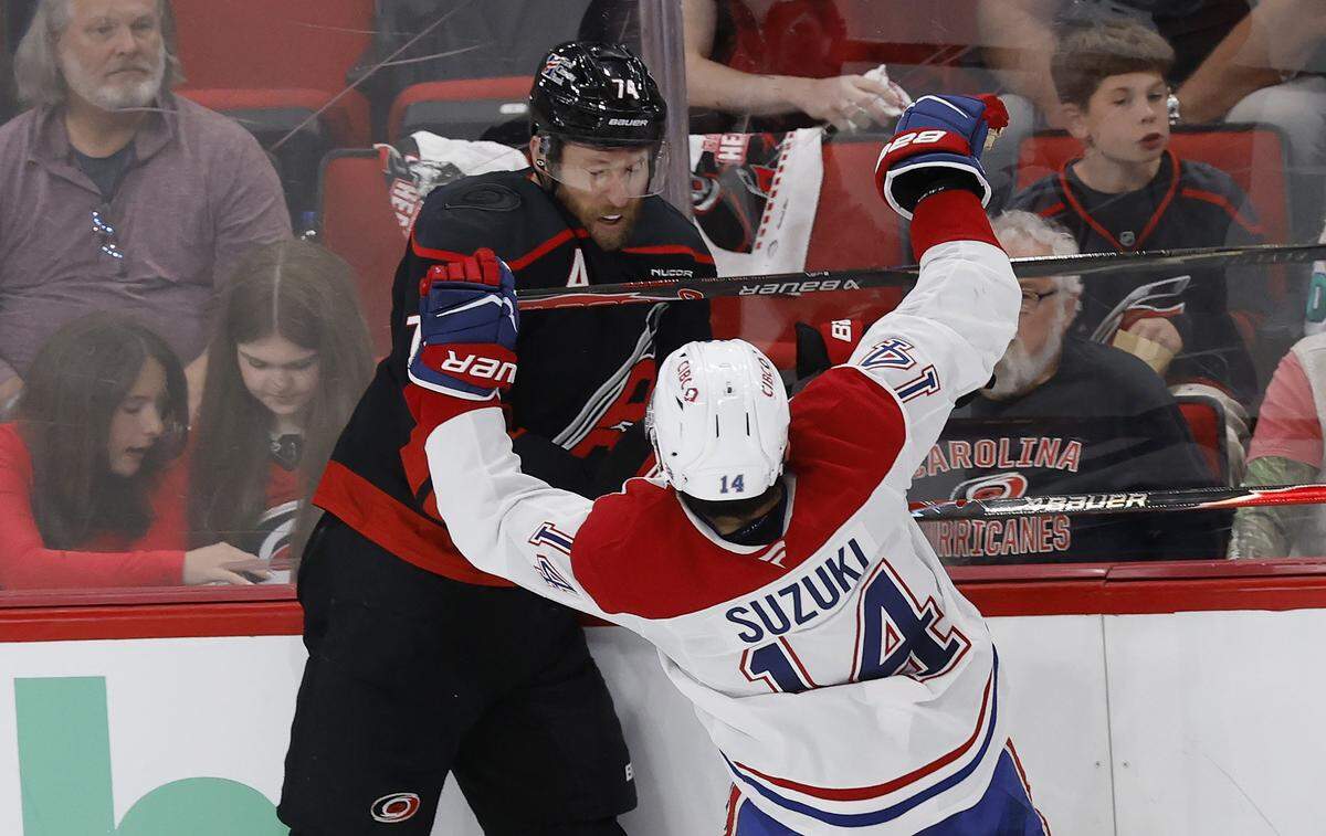 Carolina's Jaccob Slavin (74) checks Montréal's Nick Suzuki (14) in the second period of the Hurricanes’ game against the Canadiens in game two of the Eastern Conference Finals at the Lenovo Center in Raleigh, N.C., Saturday, May 23, 2026.