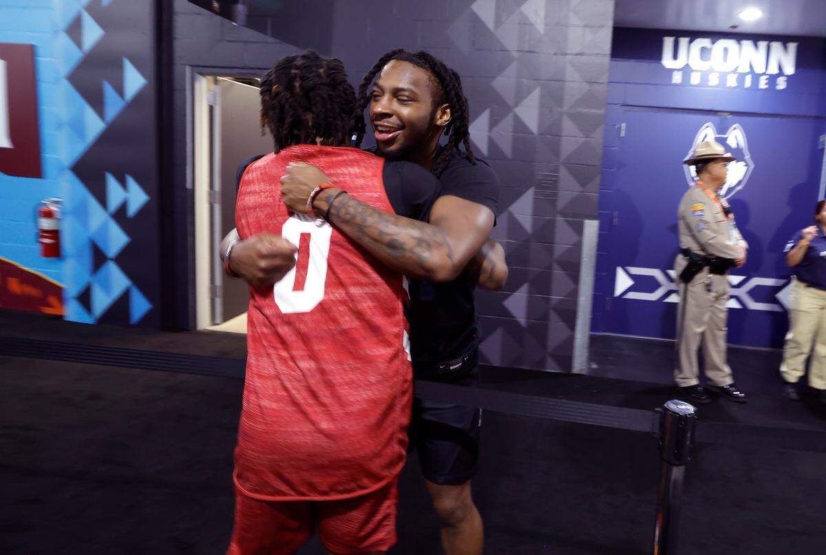 N.C. State’s DJ Horne greets Purdue’s Lance Jones in the hallway outside the locker room after N.C. State’s practice at State Farm Stadium in Glendale, Ariz., Friday, April 5, 2024. The Wolfpack will face Purdue in the NCAA Tournament national semifinals Saturday.