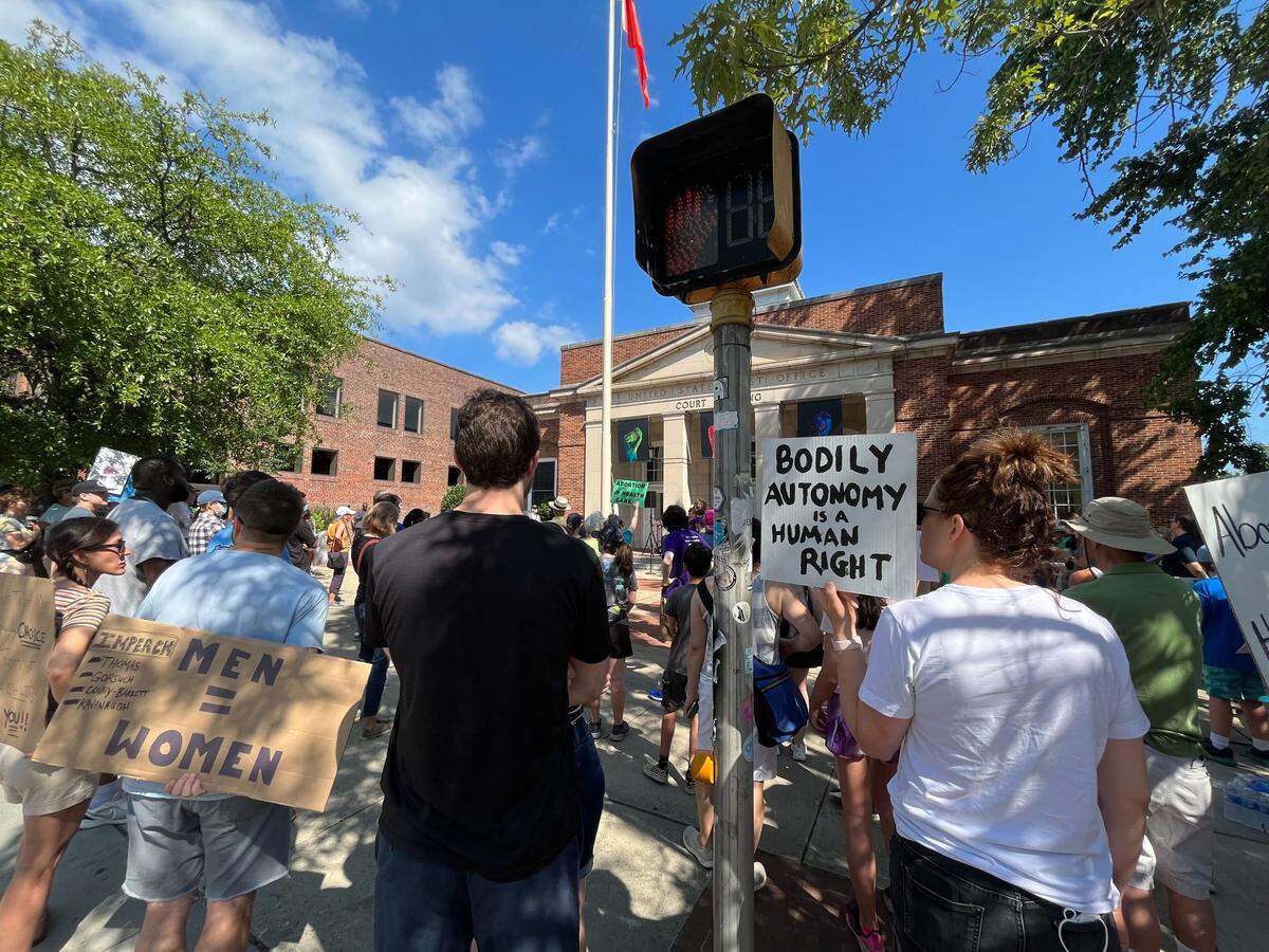 Attendees hold signs and listen to speakers at a Chapel Hill rally to “protect women’s rights” the U.S. Supreme Court overturned Roe v. Wade.