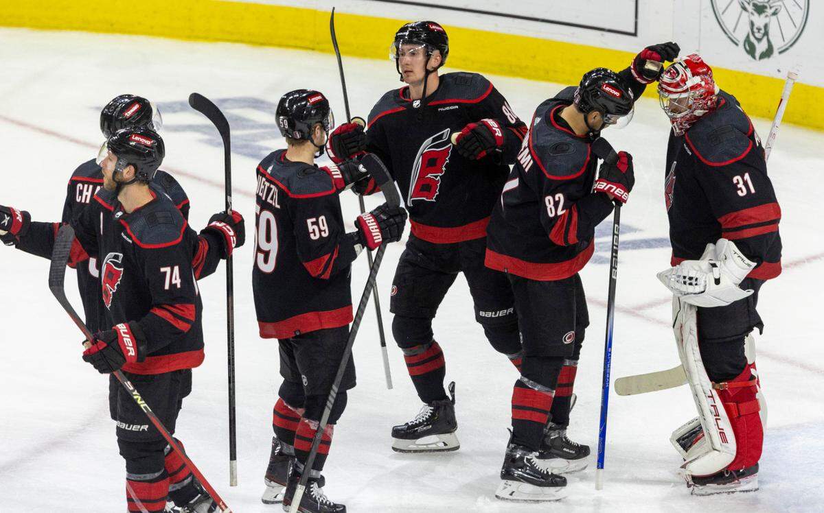 Carolina Hurricanes center Jesperi Kotkaniemi (82) congratulates goalie Frederik Anderson (31)following their 6-3 victory over the New York Islanders in Game 5 of the NHL Eastern Conference quarterfinals on Tuesday, April 30, 2024 at PNC Arena in Raleigh N.C.