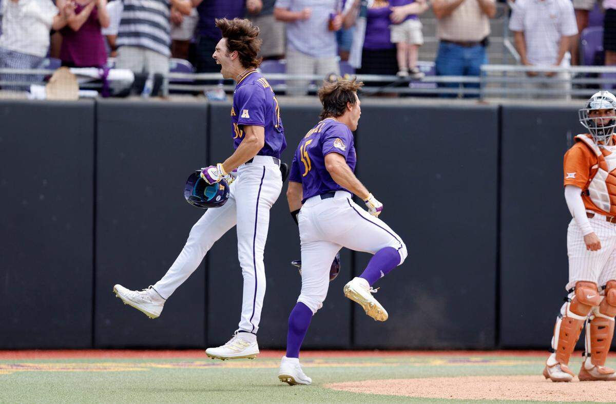 East Carolina’s Jacob Jenkins-Cowart (30), left, celebrates with Bryson Worrell (35) after hitting a three-run homerun in the fifth inning during ECUs game against Texas in the Greenville Super Regional at Clark-LeClair Stadium Saturday, June 11, 2022.