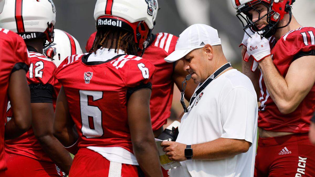 N.C. State defensive coordinator Tony Gibson works with the defense including Jakeen Harris (6) and Payton Wilson (11) during the Wolfpack’s first fall practice in Raleigh, N.C., Wednesday, August 2, 2023.