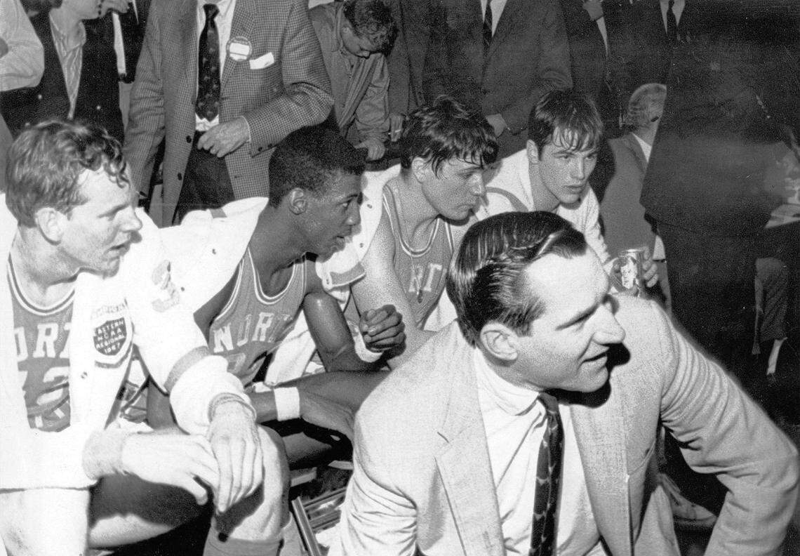 Rusty Clark, Charlie Scott, Larry Miller, Dick Grubar on the bench with UNC coach Dean Smith.