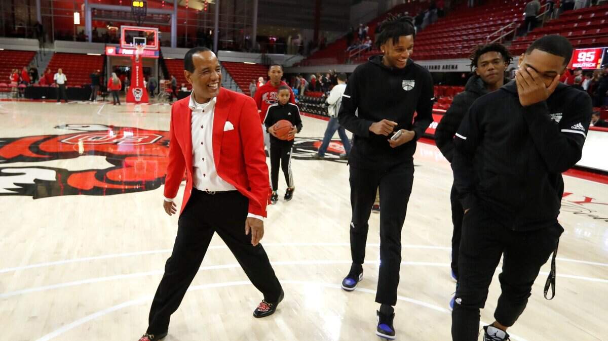 N.C. State head coach Kevin Keatts laughs with signees Josh Hall, center, and Shakeel Moore, right, after the Wolfpack’s victory over St. Francis Brooklyn at Reynolds Coliseum in Raleigh, N.C., Saturday, Nov. 16, 2019. In the center is Moravian Prep teammate Jordan Wildy.