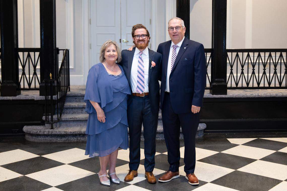 Andrew Carter (middle) with his parents, Julie and Tim Pearce.
