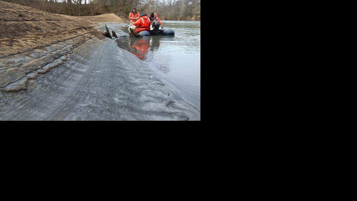 Tom Augspurger, left, with the USFWS, takes a core sample during February 8th reconnaissance of Dan River coal ash spill. From left, Tom Augspurger, USFWS, John Fridell, USFWS, Rick Smith, Duke Energy.
