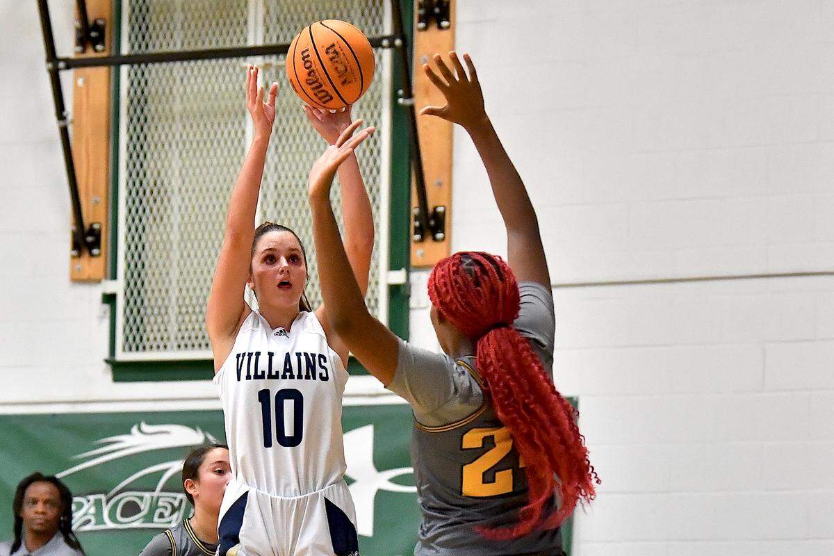 Bishop McGuinness guard Adelaide Jernigan (10) launches the jump shot over Fairmont’s Taniya Simms (24) during the first half. The Bishop McGuinness Villains and the Fairmont Golden Tornadoes met in the John Wall Holiday Invitational Tournament in Raleigh, N.C. on December 27, 2024.