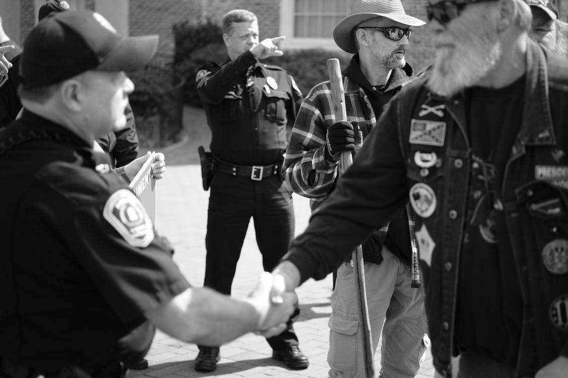 Pro-Confederate demonstrators talk with UNC-Chapel Hill police who asked them to leave campus because they were carrying weapons on Saturday, March 16, 2019.