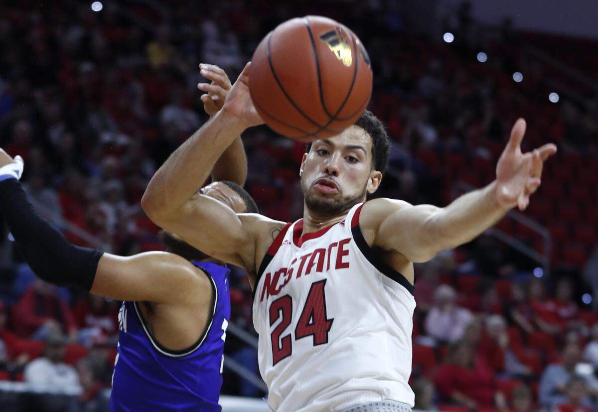 N.C. State’s Devon Daniels (24) goes after the rebound with Chowan’s Gus Rowland (11) during the second half of N.C. State’s 111-62 exhibition victory over Chowan at PNC Arena in Raleigh, N.C., Monday, Oct. 29, 2018.