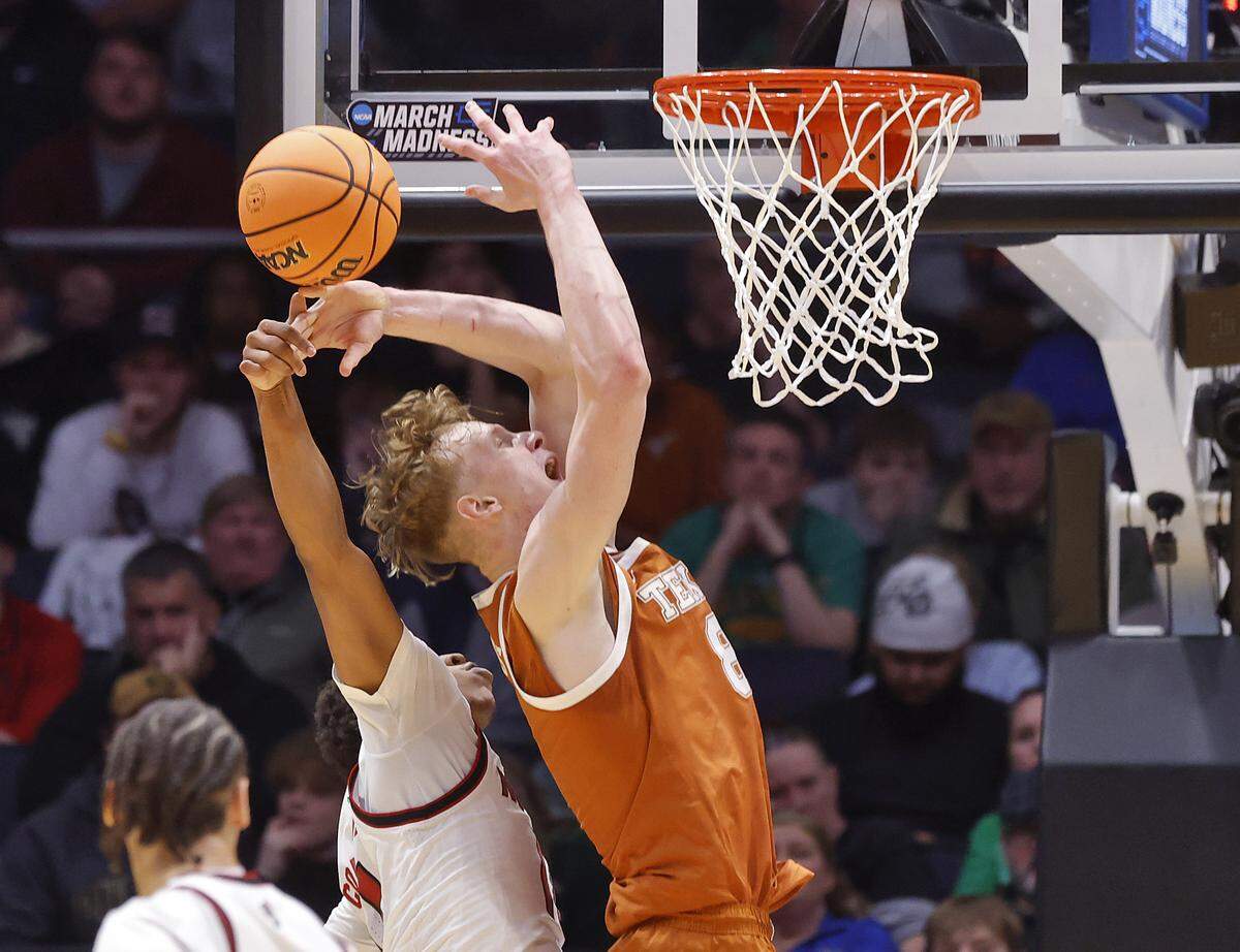 N.C. State’s Quadir Copeland blocks a shot by Texas’ Matas Vokietaitis during the first half of the Wolfpack’s 68-66 loss in the NCAA First Four on Tuesday, March 17, 2026, at the University of Dayton Arena in Dayton, Ohio. 