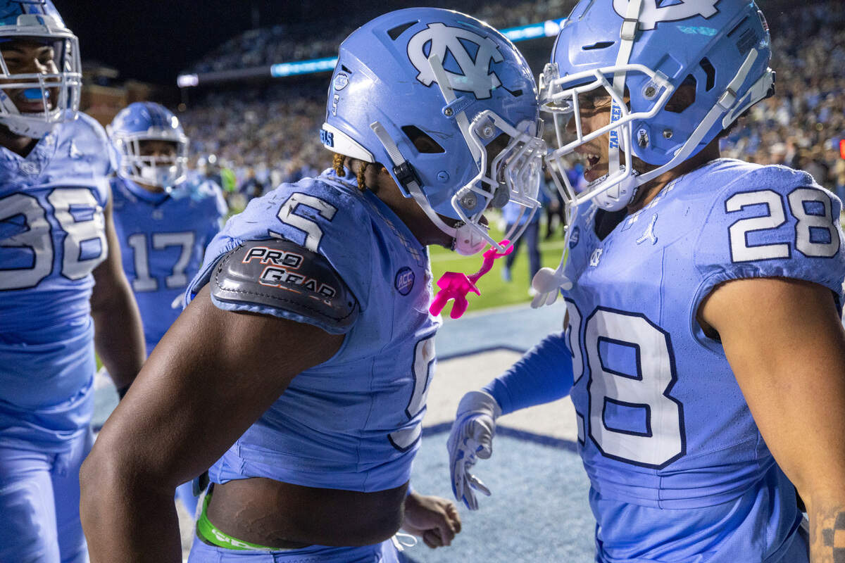 North Carolina’s Jahvaree Ritzie (5) and Alijah Huzzie (28) celebrate the Tar Heels’ 47-45 double overtime victory over Duke on Saturday, Nov. 11, 2023 at Kenan Stadium in Chapel Hill, N.C.