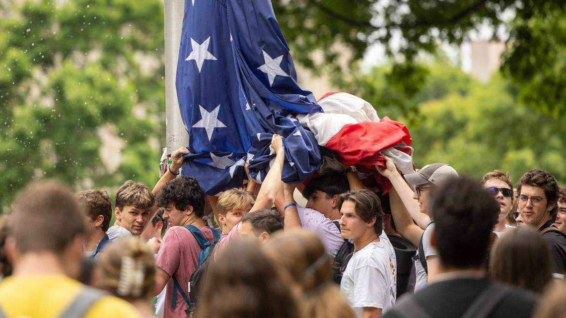A group of counter-protesters hold up an United States flag after pro-Palestinian protesters replaced the flag with a Palestinian flag on Tuesday, April 30, 2024 at UNC-Chapel Hill. Pro-Palestinian protesters clashed with police while the Palestinian flag was removed and the American flag was replaced.