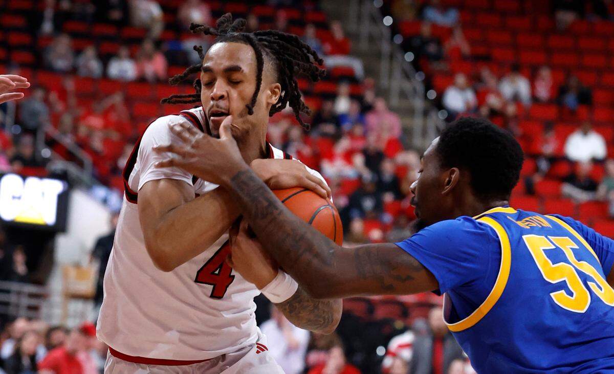 N.C. State’s Breon Pass (4) drives by Pittsburgh’s Zack Austin (55) during the second half of N.C. State’s 71-63 victory over Pitt at the Lenovo Center in Raleigh, N.C., Wednesday, March 5, 2025.