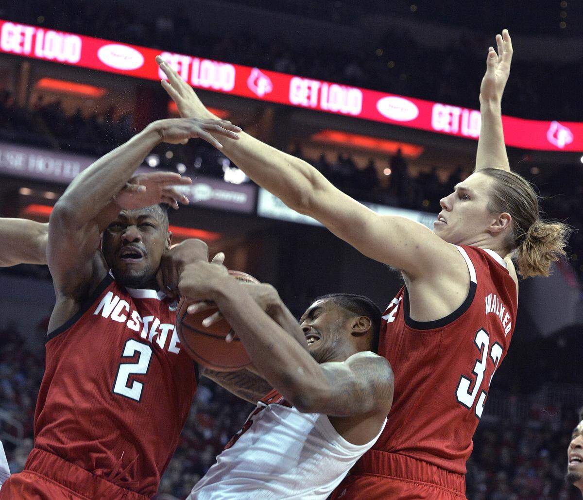 Louisville center Malik Williams and North Carolina State guard Torin Dorn (2) and forward Wyatt Walker (33) battle for a rebound during the first half of an NCAA college basketball game in Louisville, Ky., Thursday, Jan. 24, 2019.