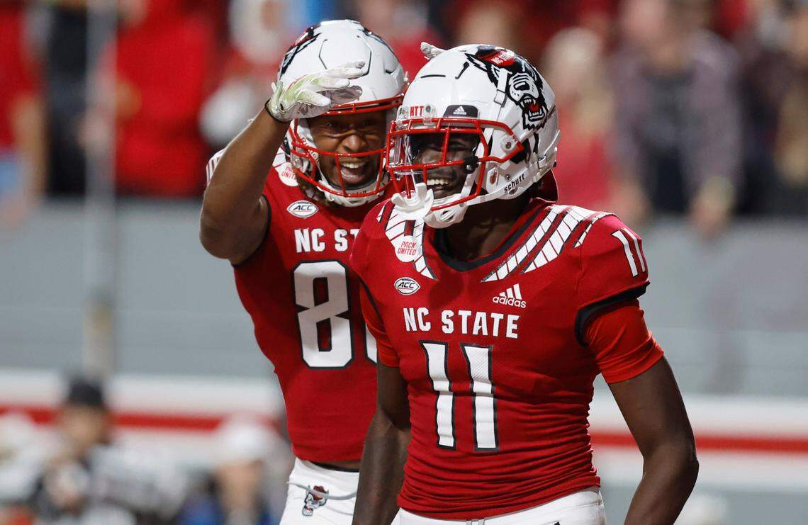 N.C. State’s Devin Carter (88) celebrates with Darryl Jones (11) after Jones made a 10-yard touchdown reception during the second half of N.C. State’s game against Florida State at Carter-Finley Stadium in Raleigh, N.C., Saturday, Oct. 8, 2022.