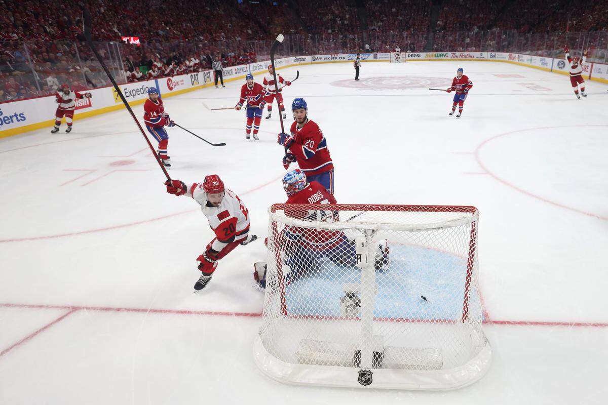 Carolina Hurricanes forward Sebastian Aho, left, celebrates as the puck gets past Montreal Canadiens goalie Jakub Dobes on a shot by the Hurricanes’ Andrei Svechnikov during overtime of Game 3 of the Eastern Conference Final of the 2026 Stanley Cup Playoffs at Bell Centre on May 25, 2026 in Montreal, Quebec, Canada.
