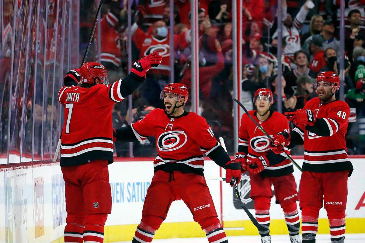Carolina Hurricanes’ Brendan Smith (7) is congratulated on his go-ahead goal by Vincent Trocheck (16), Jordan Martinook (48) and Teuvo Teravainen (86) during the third period of an NHL hockey game against the St. Louis Blues in Raleigh, N.C., Saturday, Nov. 13, 2021. (AP Photo/Karl B DeBlaker)