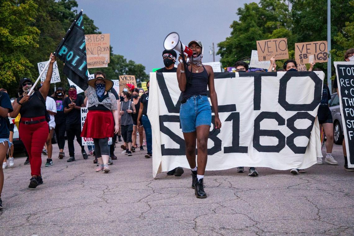 Toni Bumba, an N.C. Born organizer, leads a group of protesters down Jones Street on the 35th consecutive night of Black Lives Matter protests and 6th night of camping on the sidewalk in front of the Executive Mansion demanding Gov. Roy Cooper veto SB168, a bill that would limit public access to death-investigation records, on Saturday, July 4, 2020, in Raleigh, N.C.