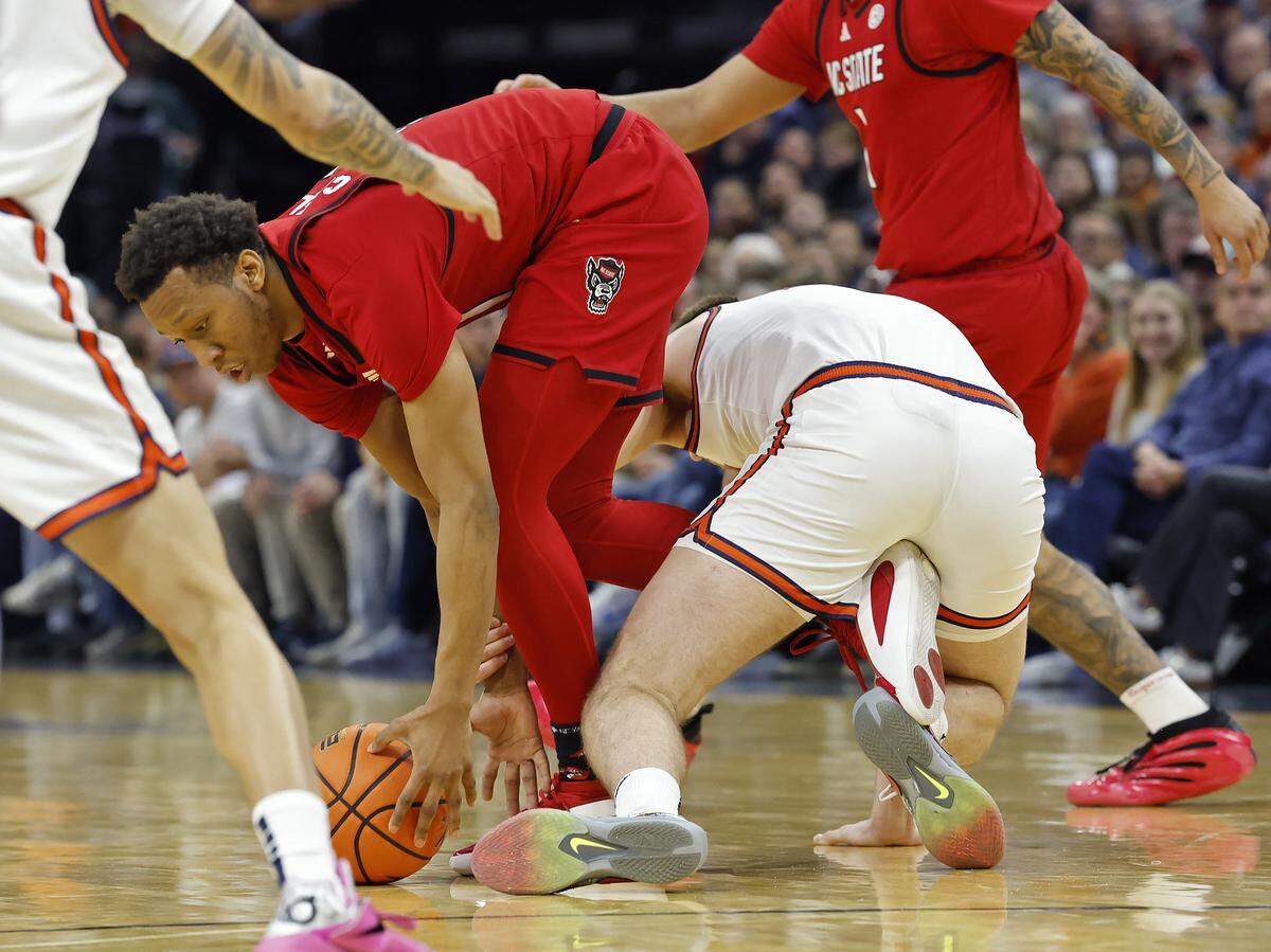 N.C. State's Quadir Copeland works against Virginia's Thijs de Ridder during the second half of the Wolfpack’s 90-61 loss on Thursday, Feb. 24, 2026, at John Paul Jones Arena in Charlottesville, Va.