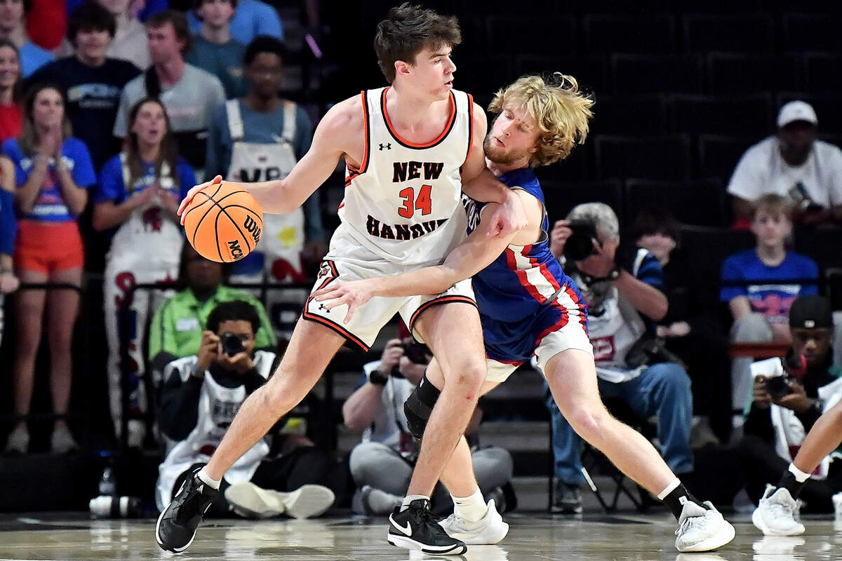 Sanderson’s Benjamin Ellison (3) pressures New Hanover’s Nolan Billings (34) during the first half. The Sanderson Spartans and the New Hanover Wildcats met in the NCHSAA 4A East Regional Final in Winston-Salem, N.C. on March 12, 2025.